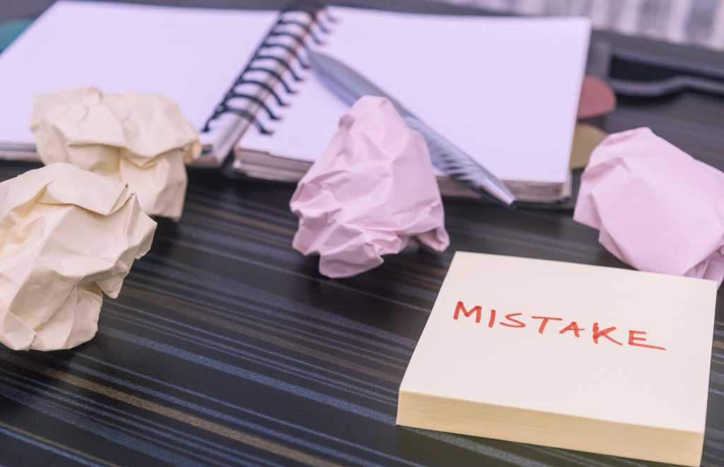 The word "Mistake" written on a sticky note.