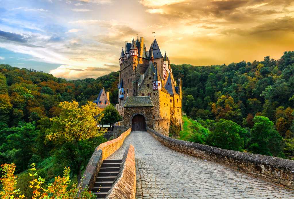 romantic medieval castle in autumn colours over sunset in Burg Eltz, Germany, one of the most beautiful castles in Europe