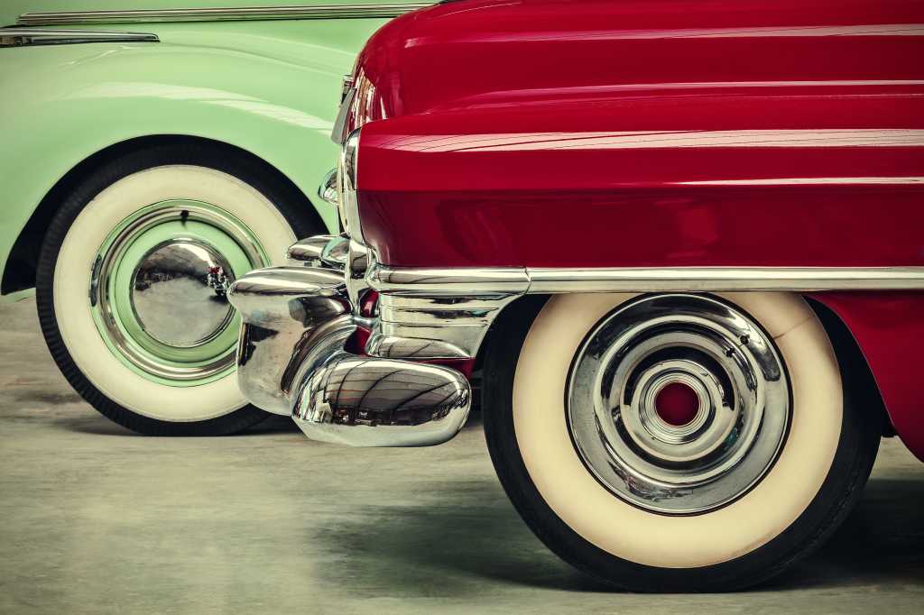 shutterstock 217379119 green and red vintage American cars parked next to each other