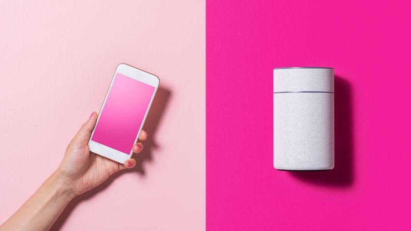 smartphone and smart speaker on pink background