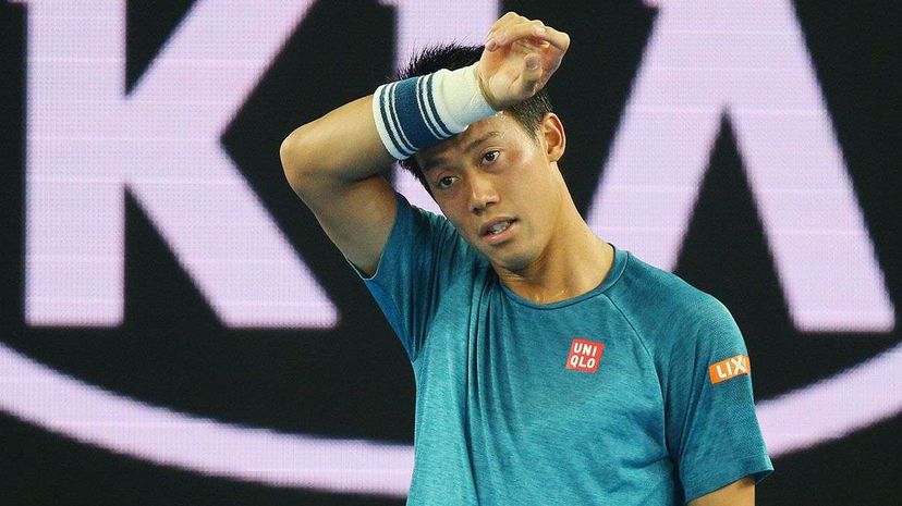 Tennis pro Kei Nishikori wipes sweat away while competing during the 2016 Australian Open. Michael Dodge/Getty Images