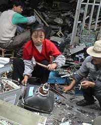 This woman in Guiyu, China, was about to smash the cathode ray tube off a computer monitor to retrieve the copper-laden yoke. The lead-laden glass is a hazard, and toxic phosphor dust coats the inside of the monitor.