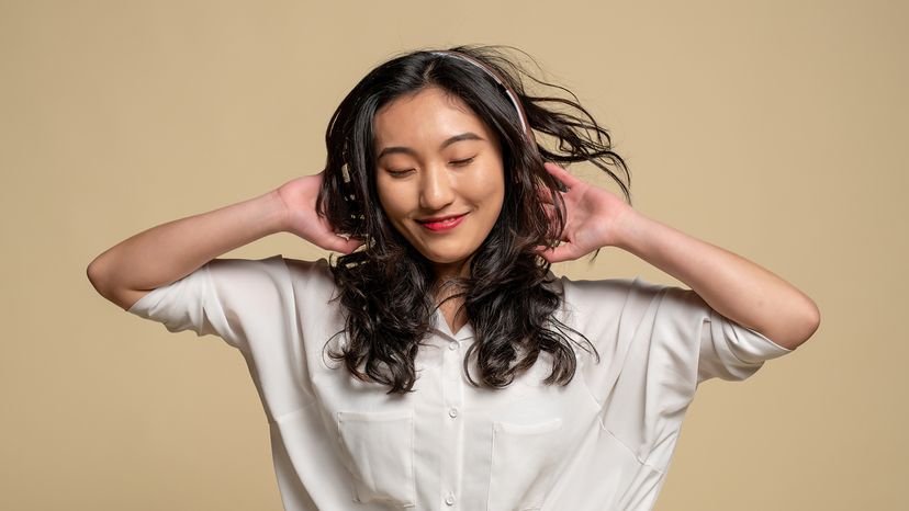Young Asian woman listening to headphones
